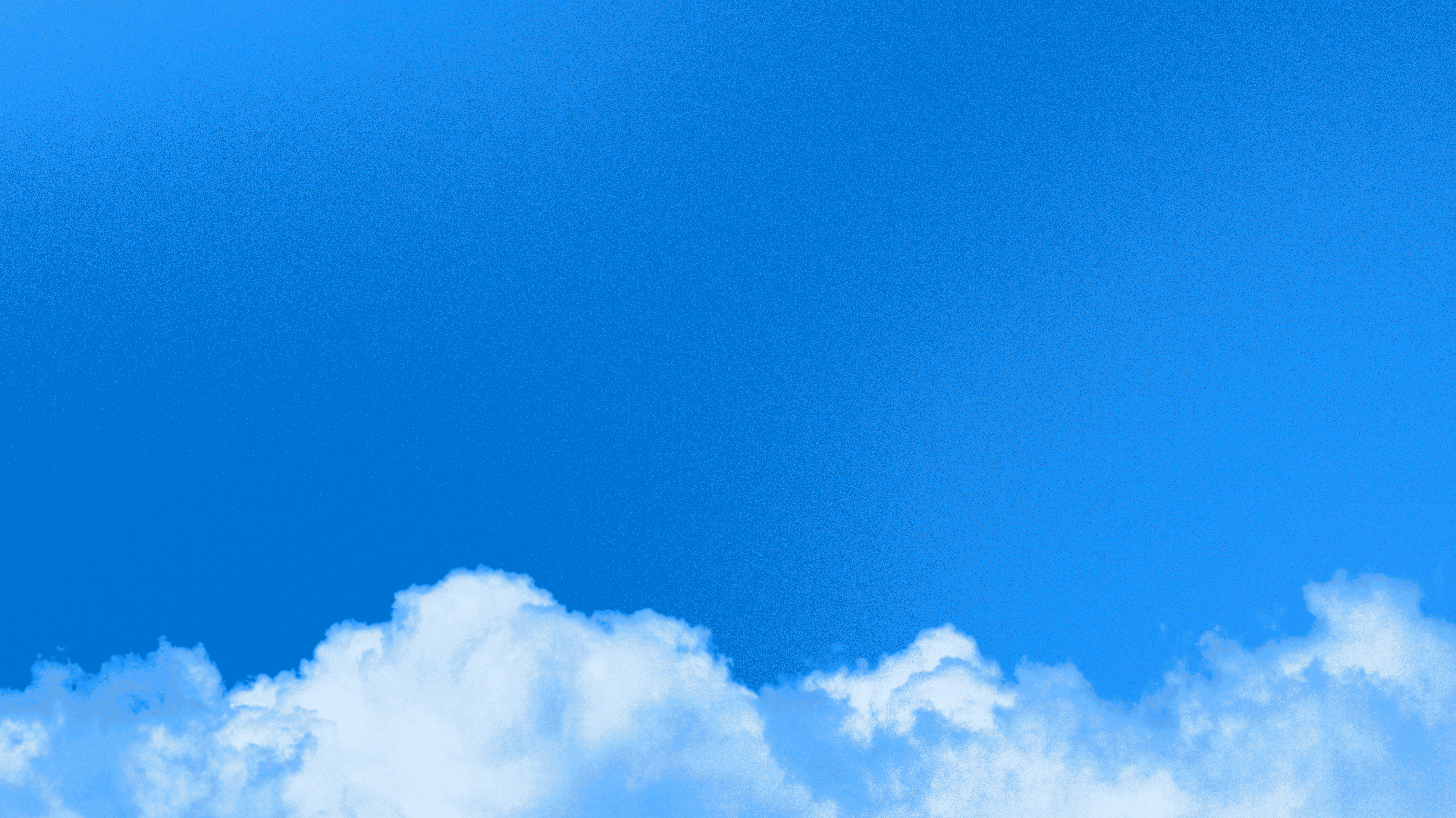 A vivid blue sky with soft clouds